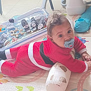 Aaron participe au concours pour gagner de l'argent avec cette photo : baby, baby_gear, child, colorful, cozy, cute, expression, face, floor, home, indoors, infant, lying_down, pacifier, person, pillow, play_mat, red_clothing, soft_toy, toy