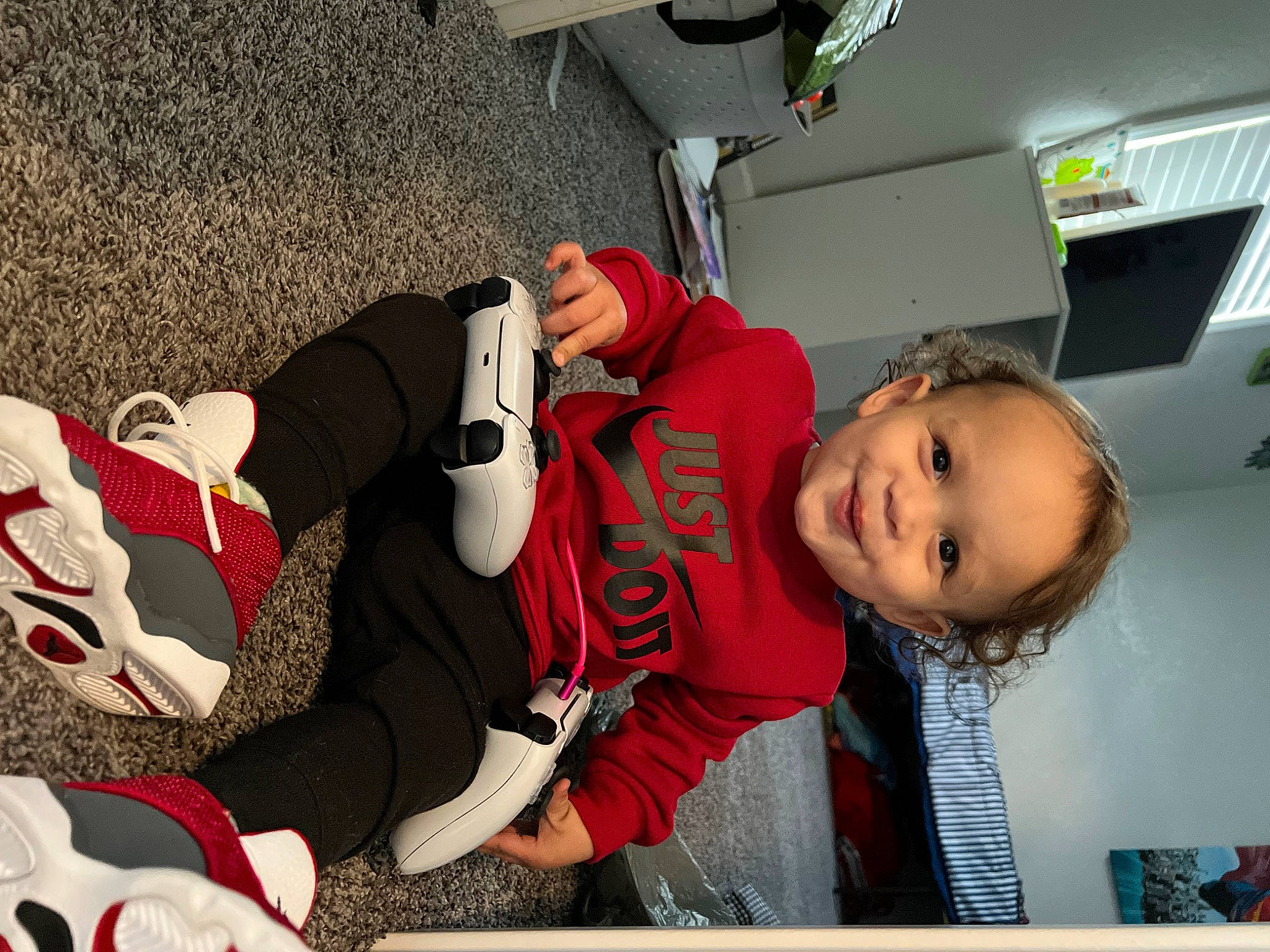 Kaius is registered to the contest to win money with this photo: automotive_design, automotive_exterior, baby, carmine, child, comfort, fun, happy, human_leg, joy, knee, lap, mouth, person, room, sitting, smile, thigh, tire, toddler