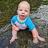 toddler, child, water, stream, rocks, blue_shirt, sitting, outdoor, nature, curious, baby, play, exploring, wet, face, hands, legs, reflection, river, summer