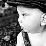 Reid joined the competition — help win amazing prizes! baby, child, black_and_white, close_up, cap, hat, face, profile, curious, outdoor, blurred_background, suspenders, young, portrait, expression, skin, headwear, infant, looking_away, monochrome