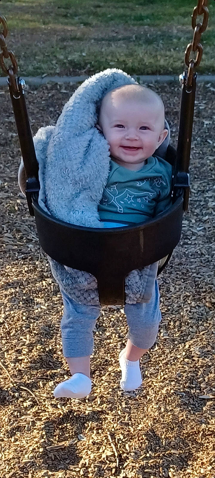 Millee is registered to the contest to win money with this photo: baby, baby_toddler_clothing, blue, clothing, electric_blue, eye, face, grass, happy, head, joy, leisure, people_in_nature, person, photograph, sleeve, smile, snapshot, standing, swing