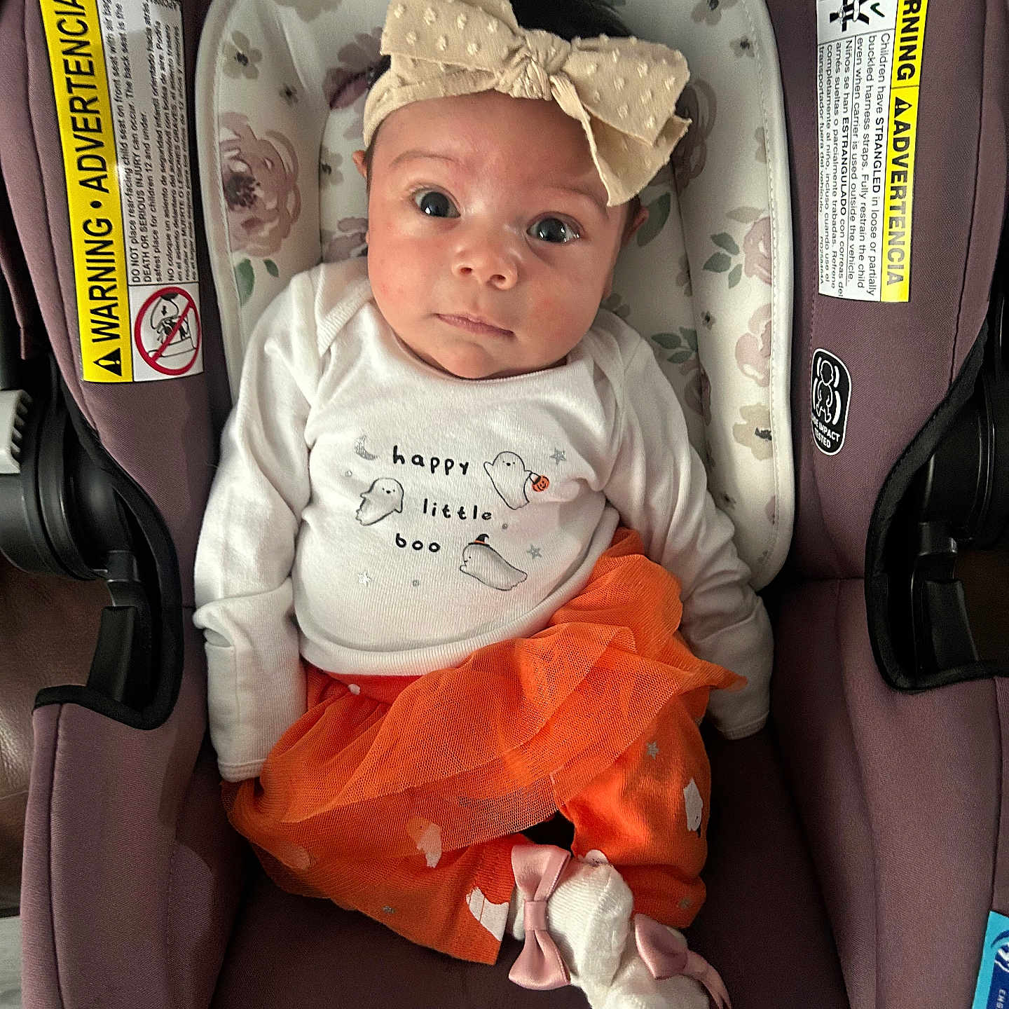 Laylin is registered to the contest to win money with this photo: baby, bow, car_seat, child, clothing, cute, floral_pattern, ghosts, happy_little_boo, headband, indoor, infant, orange, pink_bow, portrait, purple, seat, socks, tutu, white_shirt