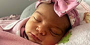 Laylin is registered to the contest to win money with this photo: baby, sleeping, pink, blanket, headband, bow, floral, face, infant, child, soft, pillow, cute, peaceful, resting, closeup, indoors, person, newborn, wrapped