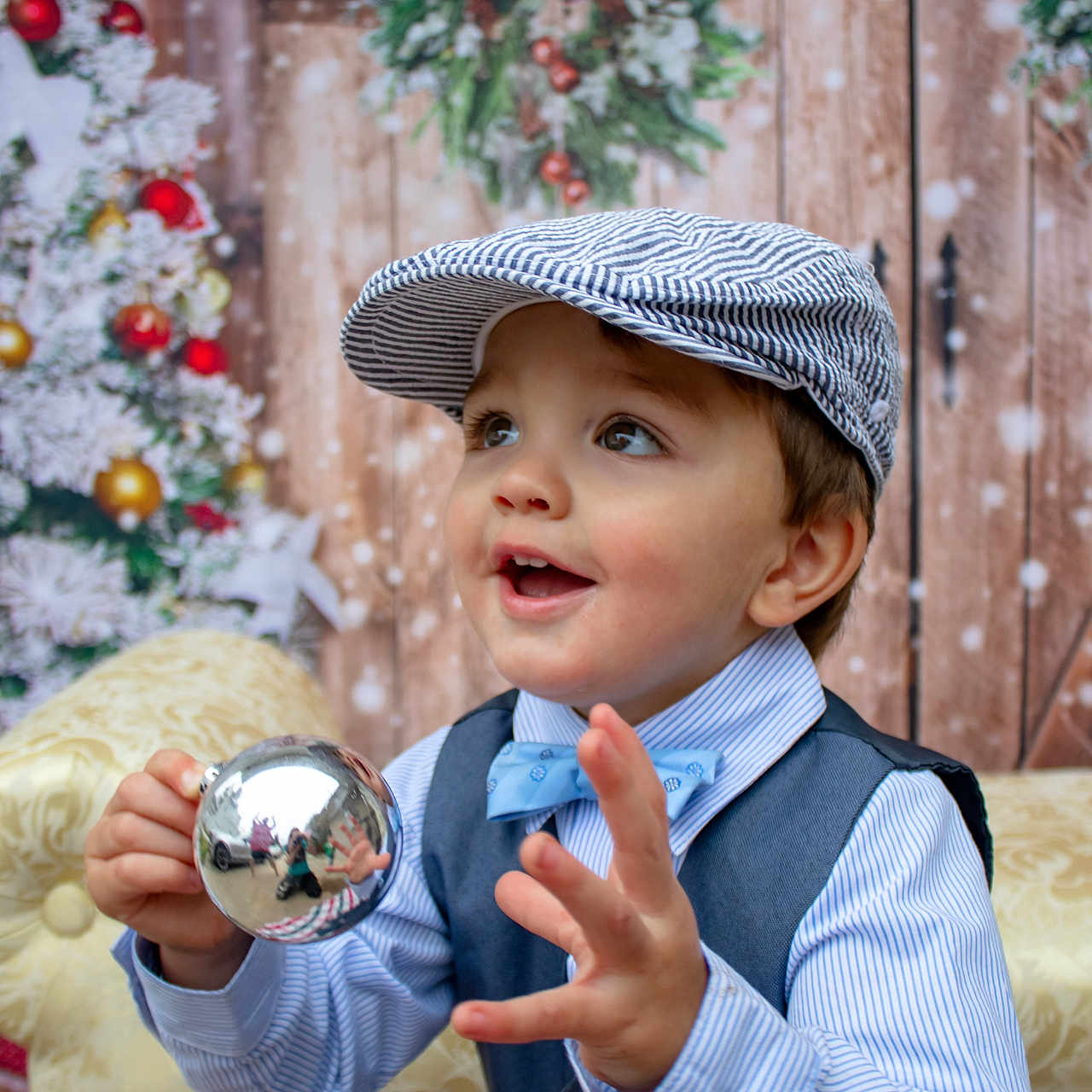 Alexander is registered to the contest to win money with this photo: accessories, baby, baseballcap, bodypart, cap, clothing, couch, face, finger, formalwear, furniture, hand, hat, head, pants, person, photography, portrait, shirt, sphere