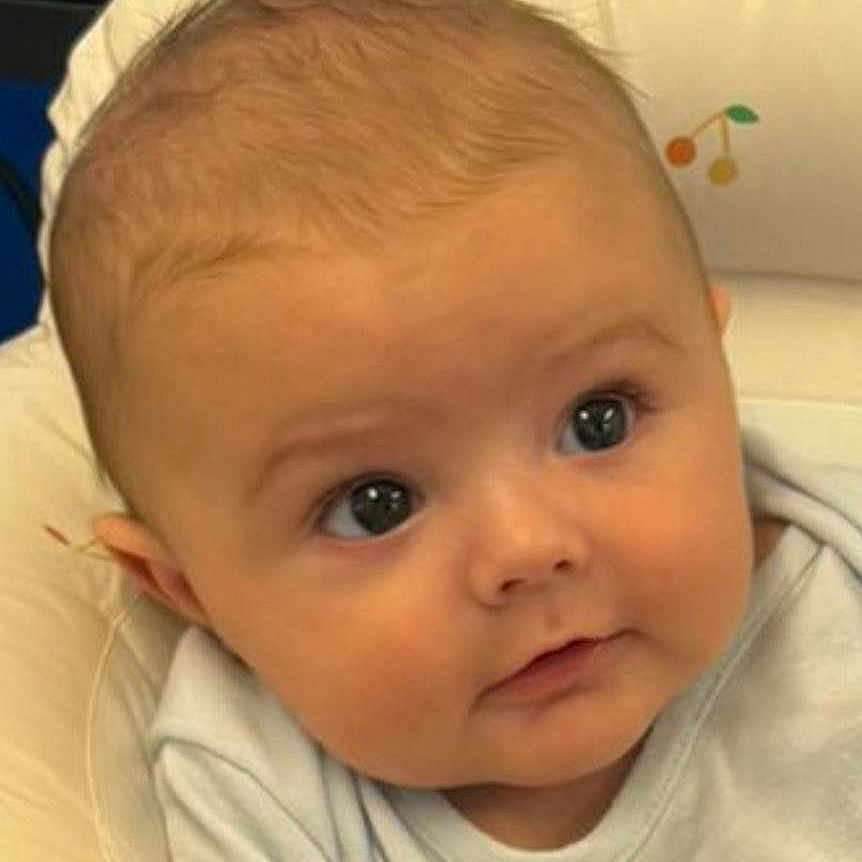 Poppy is registered to the contest to win money with this photo: baby, blonde, clothing, cushion, face, hair, happy, head, homedecor, newborn, person, photography, portrait, selfie, smile, spitting, t_shirt