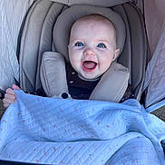 Olivia joined the competition — help win amazing prizes! baby, blanket, blue_eyes, child, clothing, cushion, cute, expression, face, happy, infant, outdoor, person, portrait, seat, smile, stroller, toy, wrapped, young_child