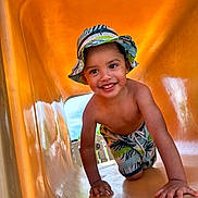 Dylan Lopez joined the competition — help win amazing prizes! child, smiling, slide, playground, hat, shorts, outdoor, summer, happy, crawling, toddler, fun, yellow, sunny, vacation, clothing, person, play, kid, recreation