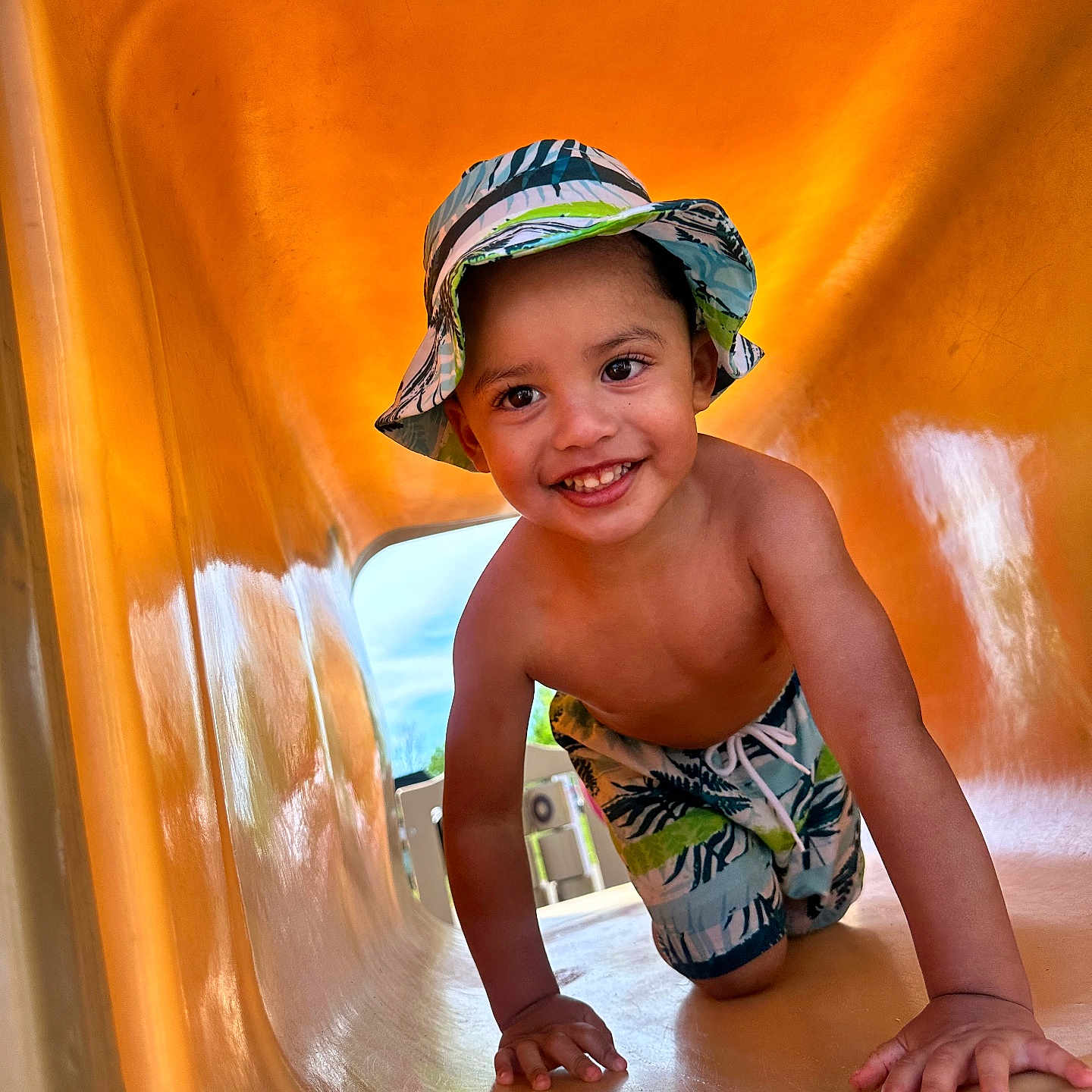 Dylan Lopez joined the competition — help win amazing prizes! child, smiling, slide, playground, hat, shorts, outdoor, summer, happy, crawling, toddler, fun, yellow, sunny, vacation, clothing, person, play, kid, recreation
