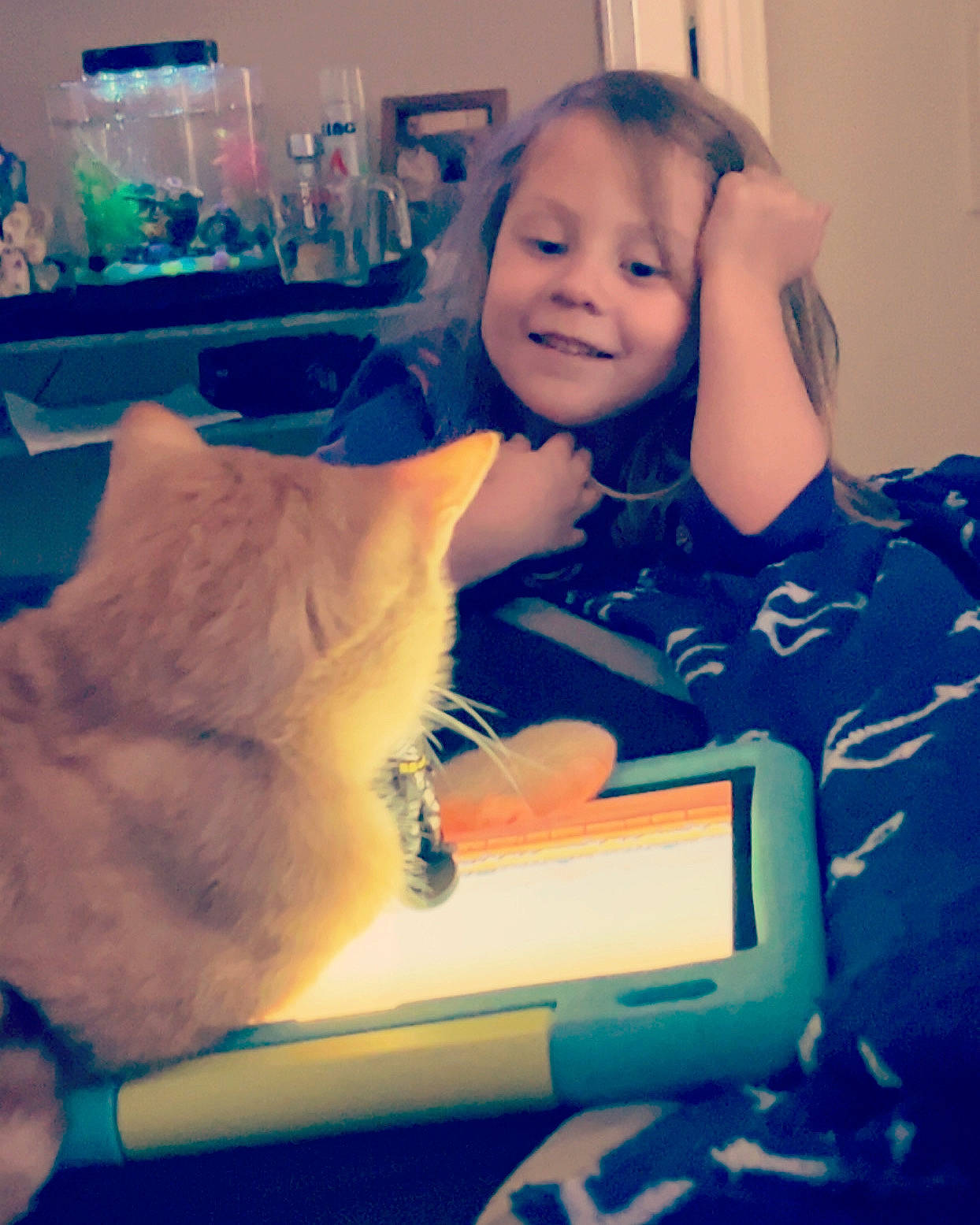 Amara is registered to the contest to win money with this photo: arm, baby_toddler_clothing, child, cloud, comfort, companion_dog, cool, electric_blue, electronic_device, felidae, finger, fun, happy, joy, mammal, person, room, sitting, small_to_medium_sized_cats, smile