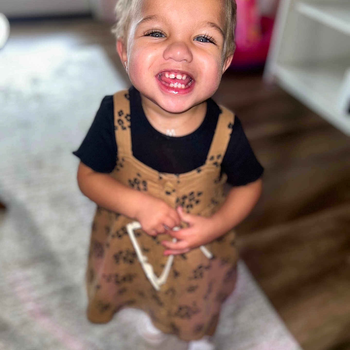 Malayah is registered to the contest to win money with this photo: accessories, baby, babylaughing, bodypart, clothing, dress, face, happy, head, jewelry, laughing, mouth, necklace, pants, person, photography, portrait, smile, teeth, wood