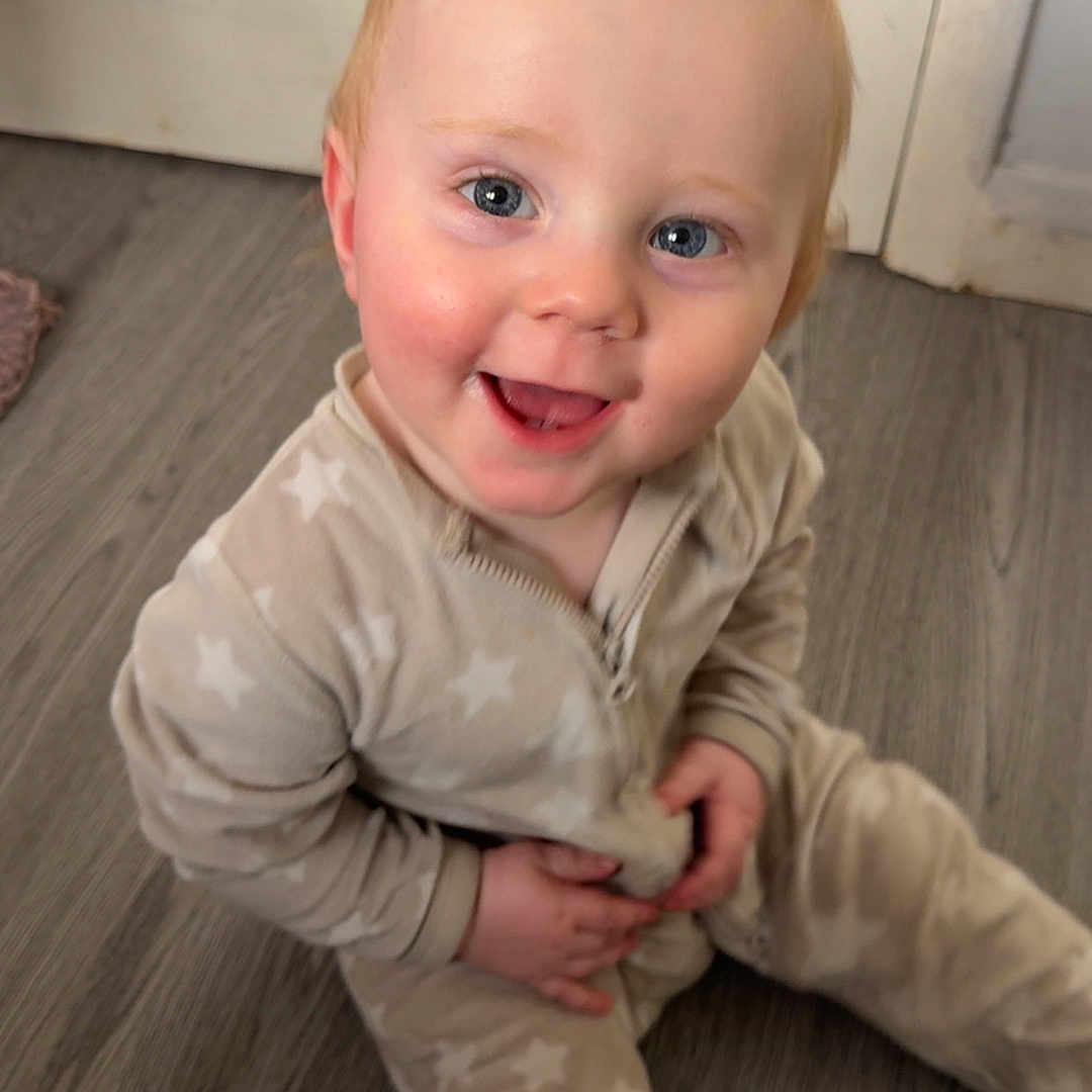 Hunter joined the competition — help win amazing prizes! baby, blue_eyes, child, cute, door, face, floor, hands, happy, home, indoor, infant, light, pajamas, portrait, sitting, smiling, star_pattern, wooden_floor, young_child