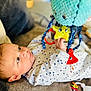 Mattéo a rejoint le concours — aidez-le/la à gagner de superbes lots ! baby, infant, child, toy, plush_toy, hand, face, star_pattern, blanket, soft_toy, indoor, couch, clothing, play, cute, toddler, colorful, focus, expression, lying_down