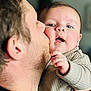 baby, man, kiss, face, cheek, skin, hand, expression, candid, indoor, portrait, love, affection, closeup, child, parent, family, warmth, clothing, person