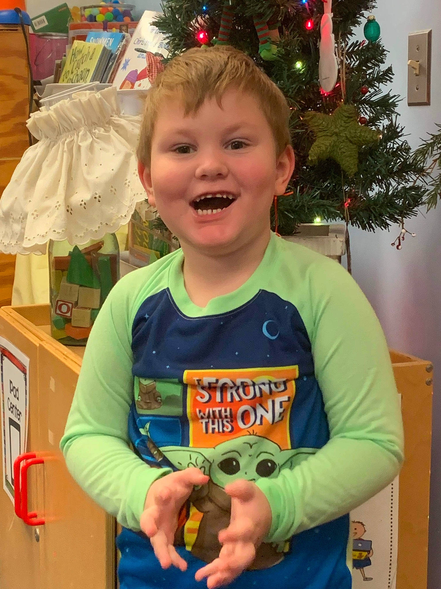 Dalton is registered to the contest to win money with this photo: child, christmas_decoration, christmas_ornament, christmas_tree, event, facial_expression, fun, green, happy, head, holiday, holiday_ornament, joy, organ, people, person, sleeve, smile, standing, t_shirt