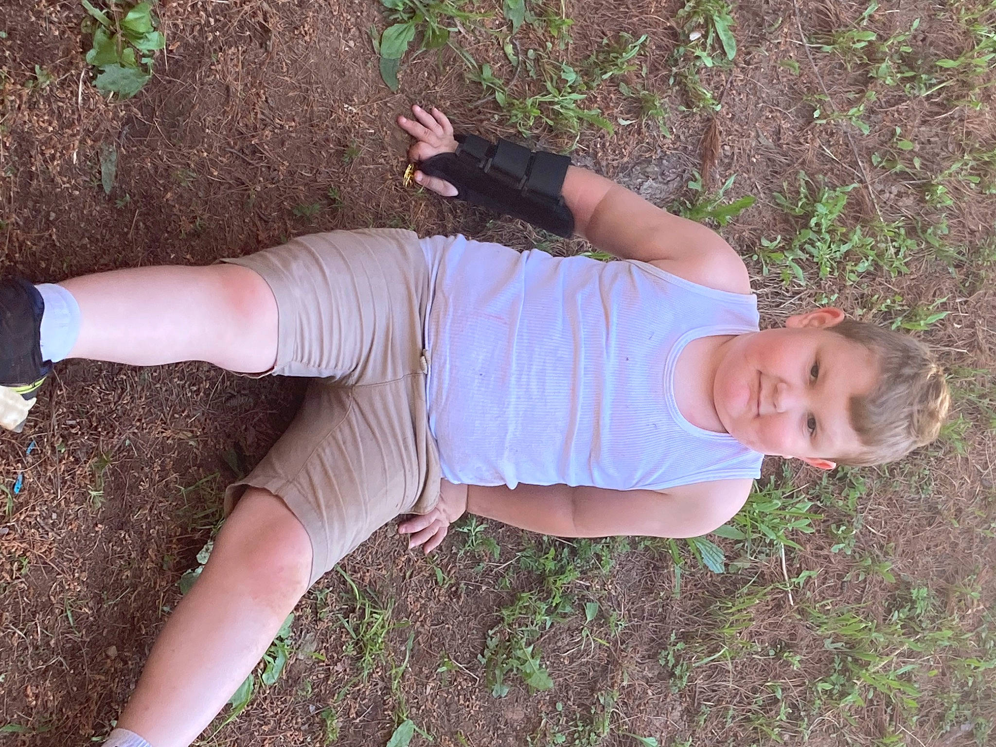 Dalton is registered to the contest to win money with this photo: calf, elbow, finger, foot, grass, green, human_leg, joint, knee, pattern, people_in_nature, person, shorts, sleeve, sock, t_shirt, thigh, thumb, toddler, waist