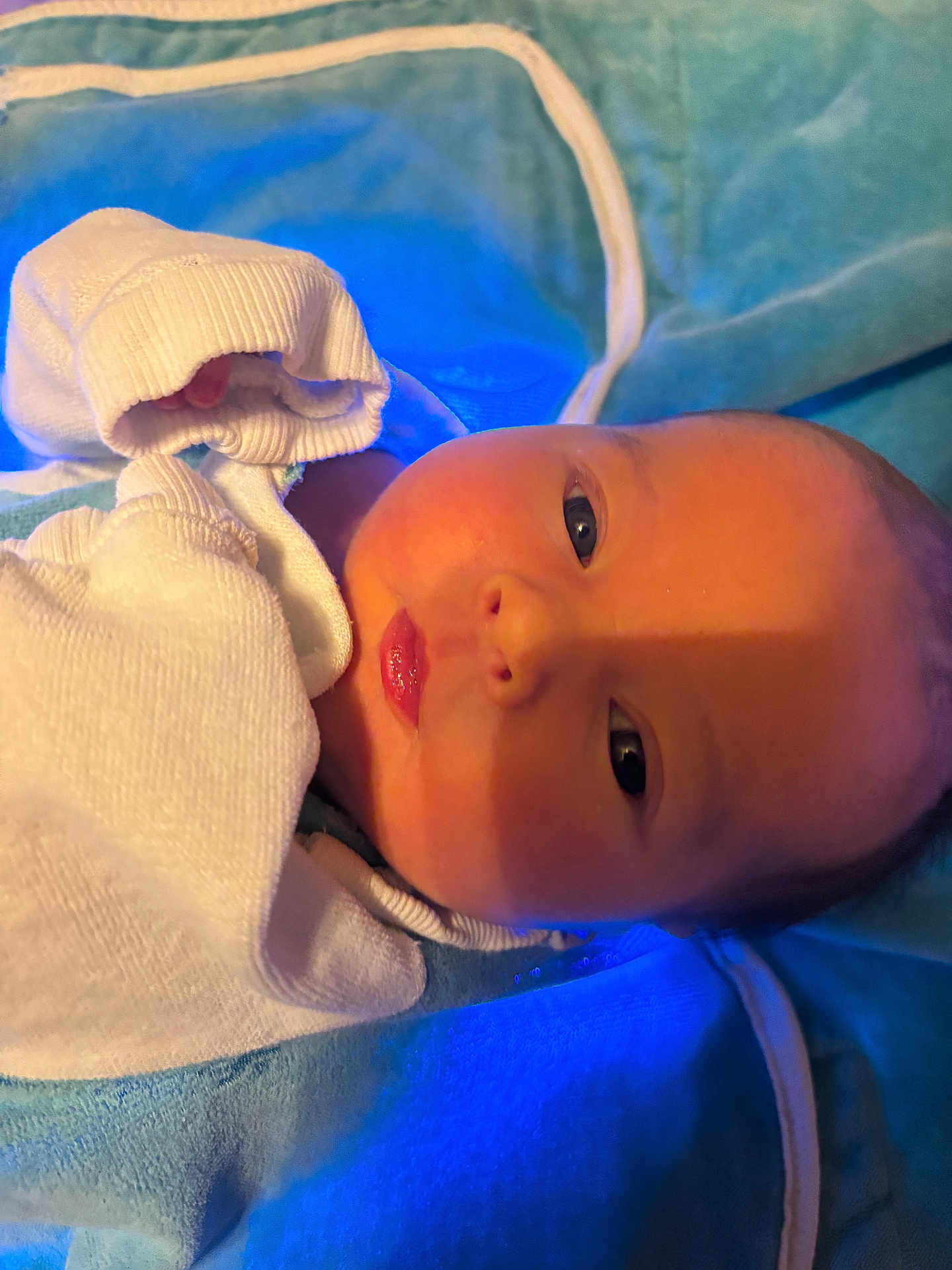 Kayleigh joined the competition — help win amazing prizes! baby, newborn, infant, swaddle, blanket, blue_light, mittens, hat, eyes_open, lips, face, skin, portrait, close_up, bedding, cozy, hospital_bedding, looking_at_camera, laying_down, newborn_care