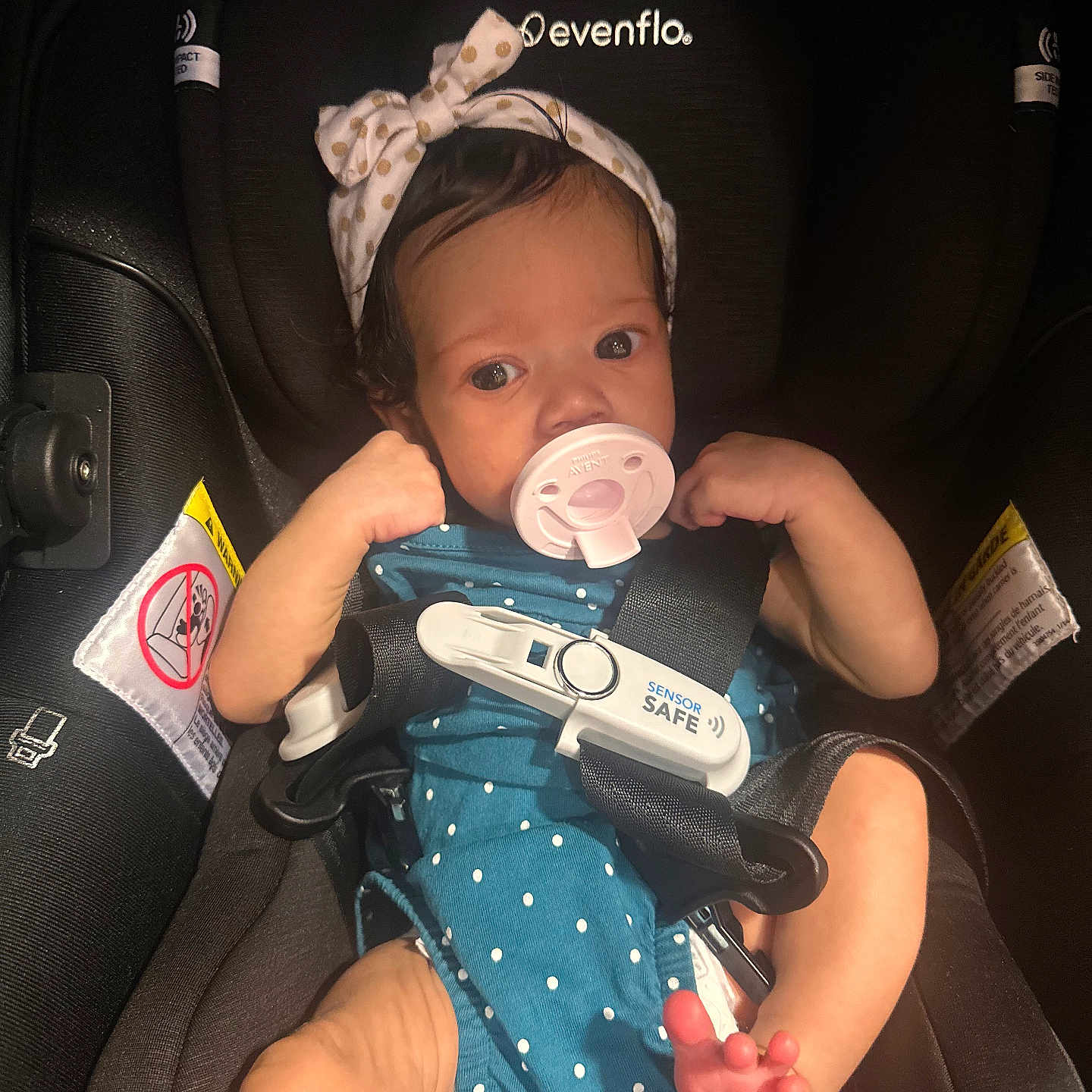 Ava joined the competition — help win amazing prizes! arm, baby, baby_girl, car_seat, child, clothing, cute, eyes, face, headband, indoor, infant, legs, newborn, pacifier, person, polka_dot, safety_harness, seatbelt, small_feet