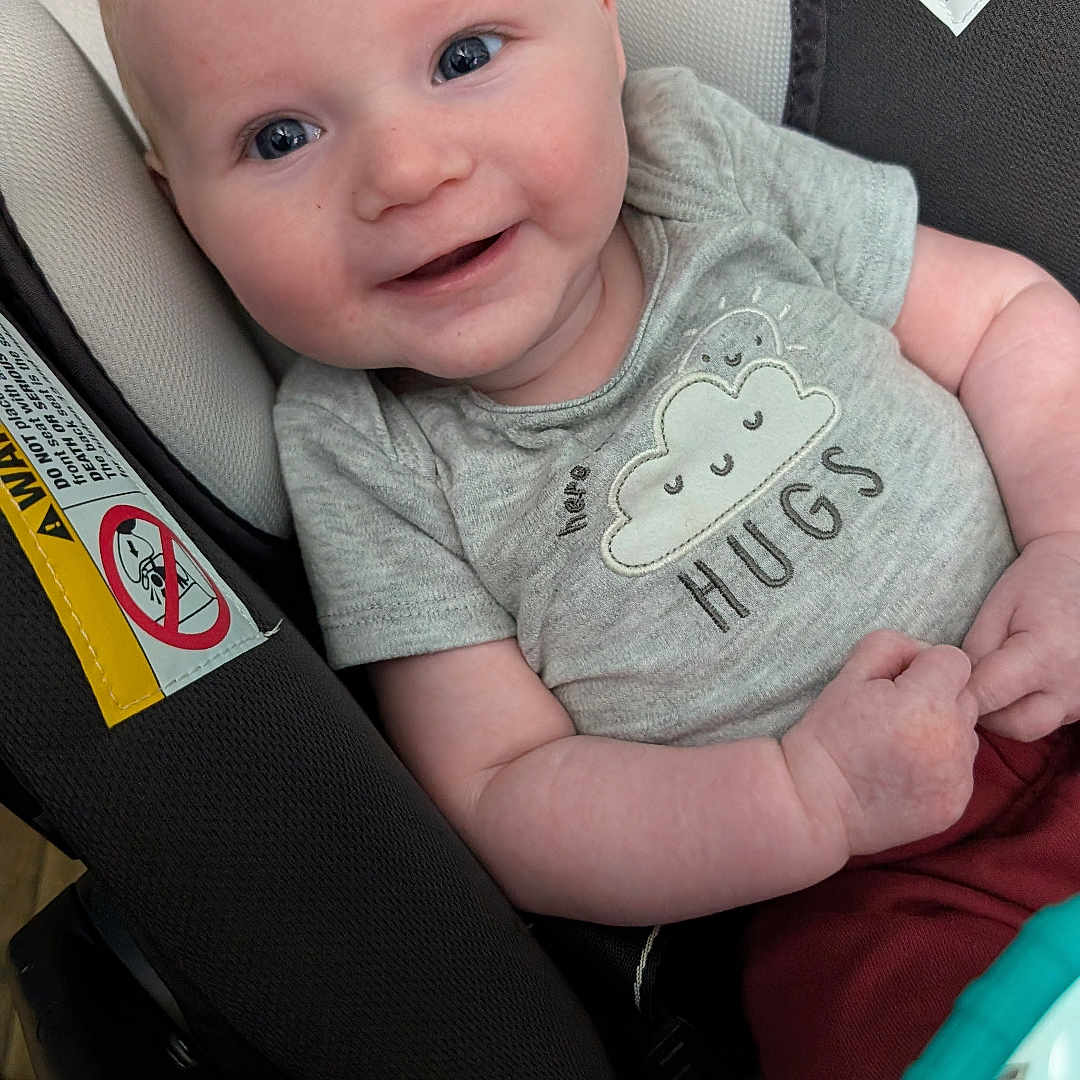 Zaylen joined the competition — help win amazing prizes! baby, bodypart, car, car_interior, clothing, cushion, face, finger, hand, happy, head, homedecor, newborn, person, photography, portrait, smile, t_shirt, transportation, vehicle