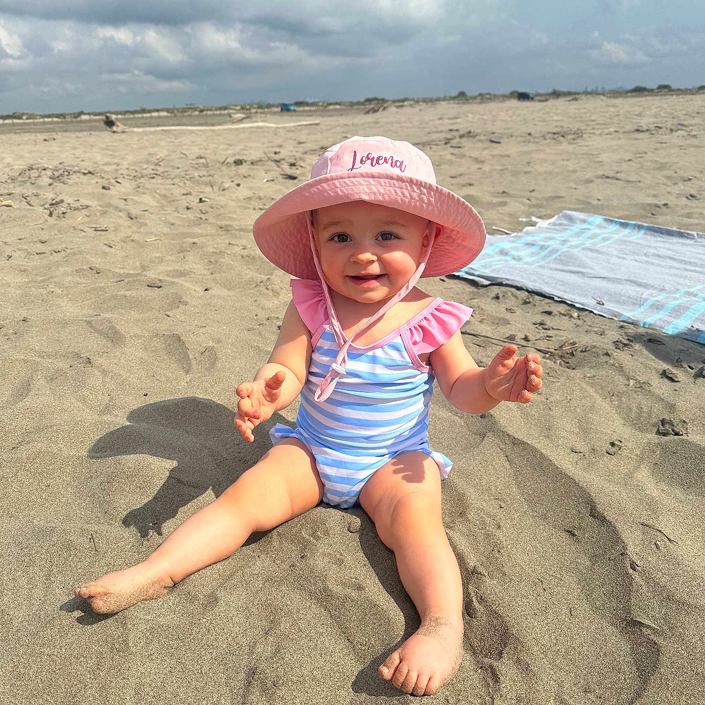 Lorena a rejoint le concours — aidez-le/la à gagner de superbes lots ! baby, beach, beachwear, clothing, coast, face, hat, head, nature, outdoors, person, photography, portrait, sea, shoreline, soil, summer, sunhat, swimwear, water