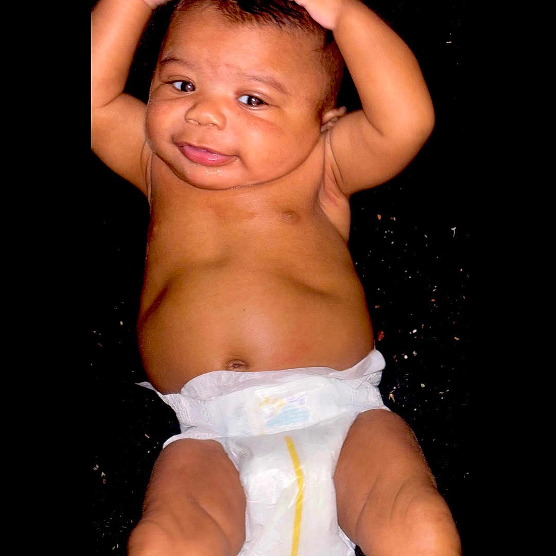 Lorrell joined the competition — help win amazing prizes! baby, back, bodypart, clothing, diaper, face, finger, hand, happy, head, mouth, newborn, person, photography, portrait, shorts, sitting, smile, swimwear, teeth