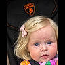 Rose joined the competition — help win amazing prizes! baby, black_stroller, blonde_hair, blue_eyes, child, close_up, colorful_clothing, floral_pattern, harness, indoors, infant, lamborghini_logo, looking_at_camera, pink_bow, portrait, safe, sitting, smiling, stroller, wood_floor