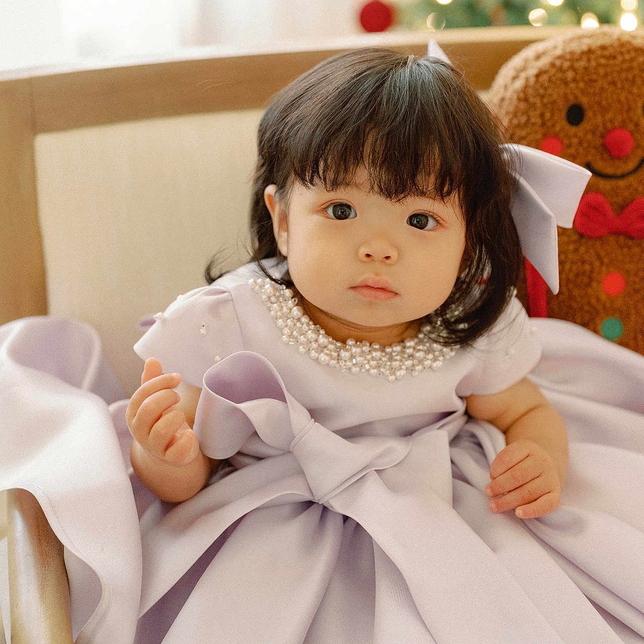 Muriel Kim is registered to the contest to win money with this photo: baby, chair, child, christmas_tree, curly_hair, cute, decor, dress, festive, gingerbread_man, holiday, indoors, lavender, pearl_necklace, plush_toy, portrait, smile, soft_light, toddler, wooden