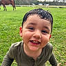 animal, background_blur, boy, casual_clothing, child, cute, daylight, field, grass, greenery, happy, horse, nature, outdoor, playful, portrait, smiling, toddler, wet_hair, young_child