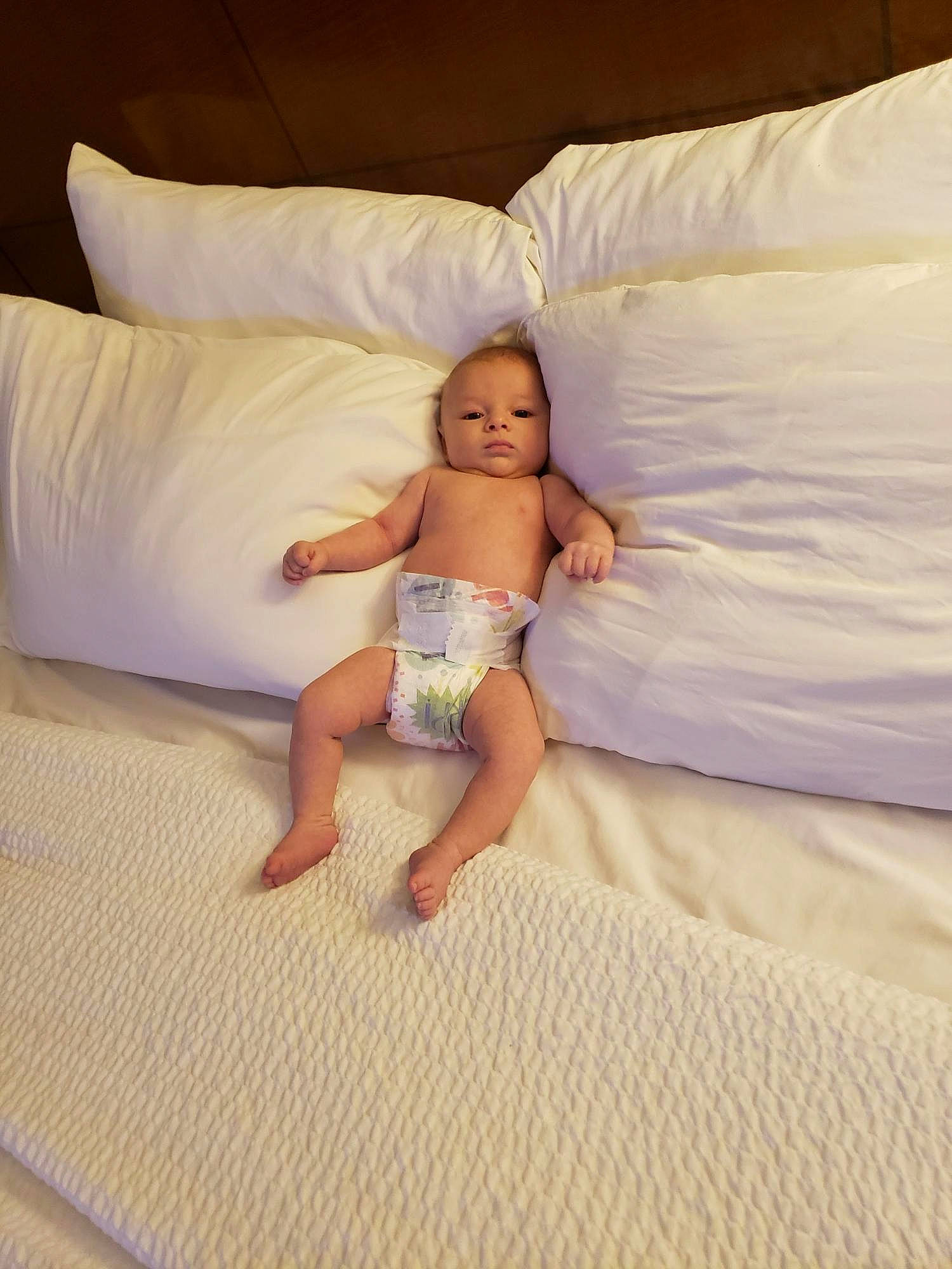 Kasen joined the competition — help win amazing prizes! baby, barefoot, bed, bed_sheet, bedding, bedroom, child, comfort, floor, flooring, fun, human_leg, linens, mattress, person, pillow, room, textile, throw_pillow, toddler