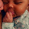 Emani joined the competition — help win amazing prizes! baby, infant, sleeping, smiling, hand, face, skin, clothing, onesie, floral_pattern, cute, peaceful, closeup, child, newborn, sleep, fingers, sparkle_effect, portrait, adorable