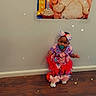 toddler, child, pacifier, bow, colorful_clothing, frilly_dress, wooden_floor, birthday_poster, baby, smiling, number_one, wall, indoor, celebration, stars, headwear, footwear, standing, cute, party