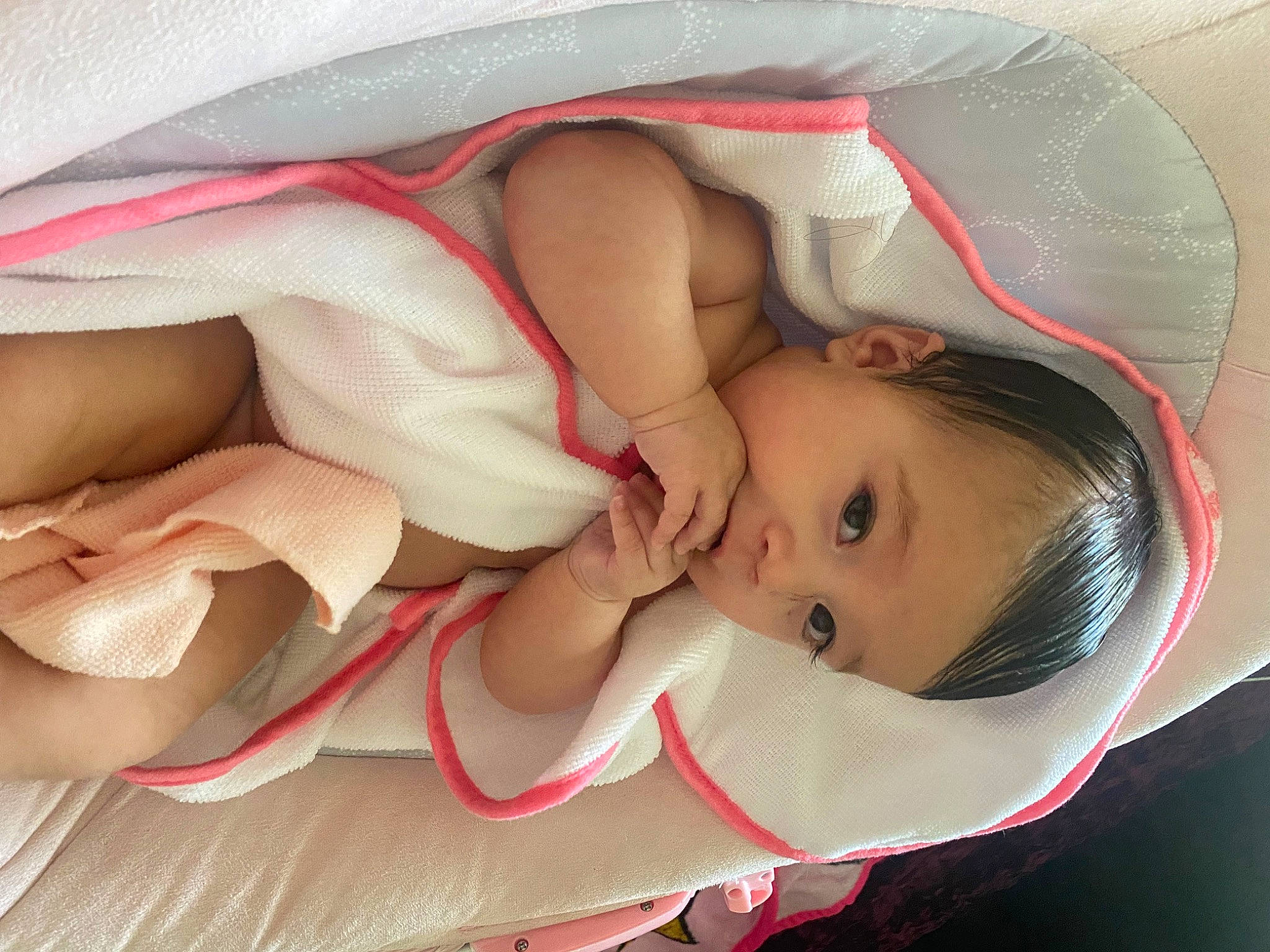 Ezra is registered to the contest to win money with this photo: baby, baby_products, baby_toddler_clothing, cheek, chest, child, comfort, eyelash, face, facial_expression, head, headgear, lip, mammal, mouth, person, pink, skin, textile, toddler