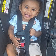 Omar joined the competition — help win amazing prizes! toddler, child, car_seat, smiling, happy, baby, straps, seatbelt, clothing, shorts, person, cute, portrait, safety, infant, young_child, baby_boy, outdoor, seat, secure
