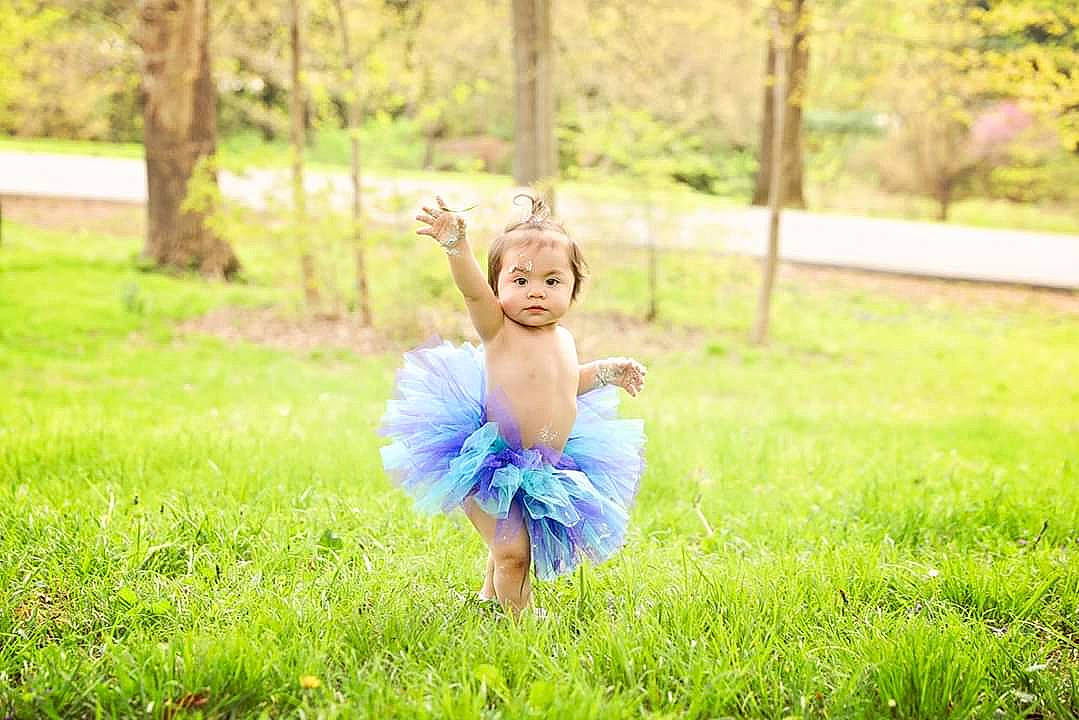 Rosabella joined the competition — help win amazing prizes! ballet_tutu, child, costume, dress, fun, grass, happy, meadow, people_in_nature, person, photograph, photography, plant, portrait, portrait_photography, sitting, smile, summer, sunlight, toddler