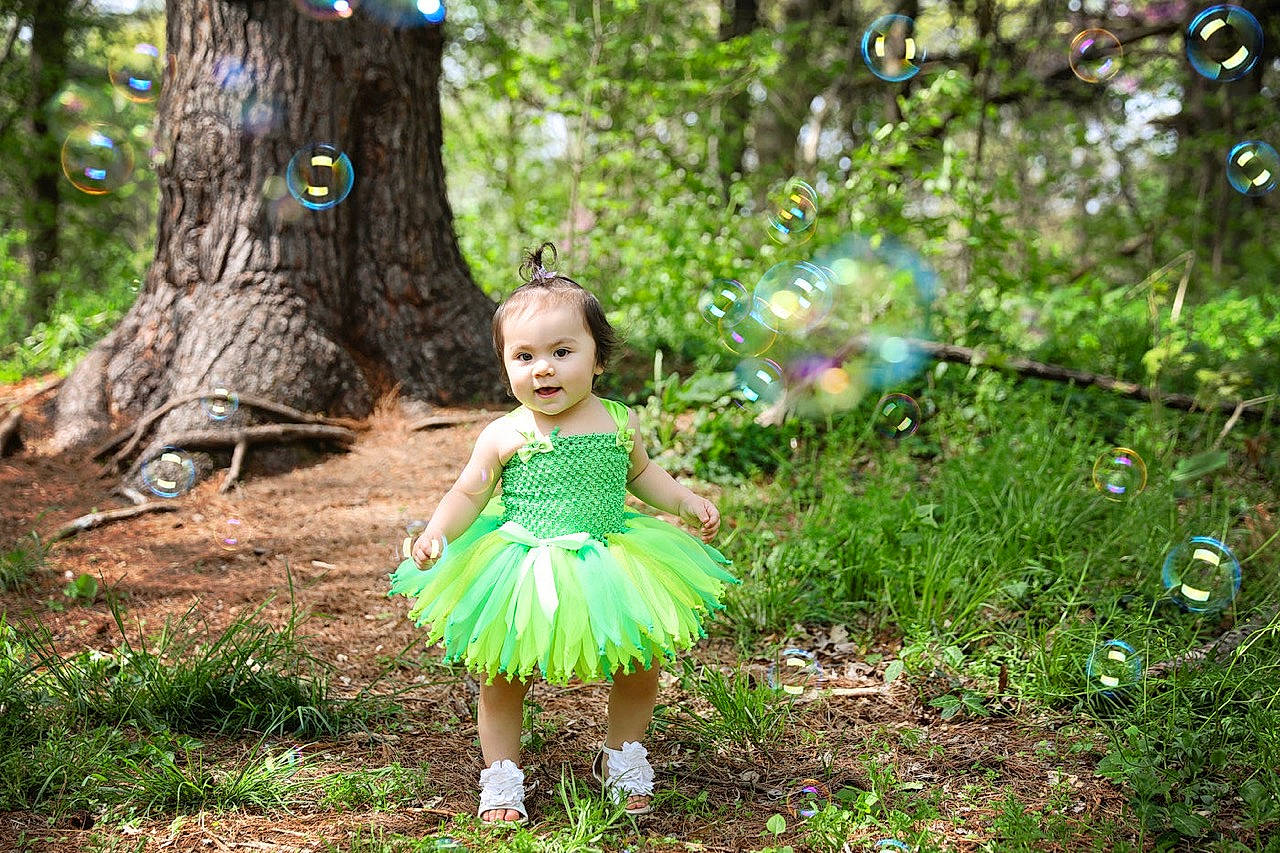 Rosabella is registered to the contest to win money with this photo: ballet_tutu, child, child_model, costume, dress, fawn, forest, fun, grass, green, leaf, natural_environment, nature, people_in_nature, person, photo_shoot, photography, plant, toddler, tree
