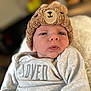 Leo joined the competition — help win amazing prizes! baby, infant, hat, bear_hat, clothing, cute, face, expression, pout, newborn, soft_focus, indoors, blanket, cozy, person, portrait, warm_tones, apparel, sitting, headwear