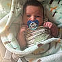 Jack is registered to the contest to win money with this photo: baby, infant, blanket, pacifier, mickey_mouse, onesie, dinosaur, stripes, cute, sleeping_bag, soft_fabric, child, newborn, hand, face, calm, indoors, closeup, cozy, portrait