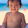 Tania is registered to the contest to win money with this photo: toddler, child, smiling, beach, ocean, sand, sunny, portrait, happy, bare_chested, hair, face, skin, outdoor, vacation, summer, person, baby, nature, relaxation