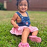 Tania is registered to the contest to win money with this photo: casual_clothing, child, cloudy_sky, curly_hair, cute, daylight, denim_overall, expression, fence, grass, greenery, nature, outdoor, pink_shoes, playful, portrait, sitting, small_person, toddler, young_child