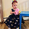 toddler, child, birthday, headband, dress, unicorn, toy, pink, blue_table, wooden_floor, indoor, person, cute, celebration, footwear, socks, floor, wall, furniture, young_child
