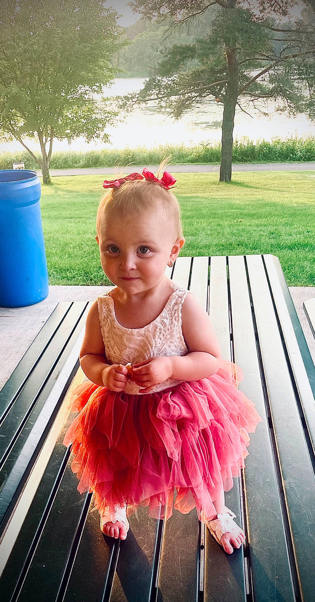 Maya is registered to the contest to win money with this photo: baby_toddler_clothing, ballet_tutu, blue, child, embellishment, fashion_accessory, fun, grass, green, happy, leisure, magenta, outdoor_furniture, person, photograph, pink, plant, snapshot, toddler, tree