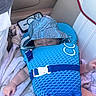 Axton joined the competition — help win amazing prizes! baby, child, sleeping, life_jacket, hat, blue, blanket, car_seat, smartphone, hand, infant, clothing, protection, seat, resting, peaceful, young, indoor, person, cute