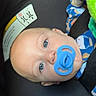 Axton is registered to the contest to win money with this photo: baby, blue_eyes, blue_outfit, car_seat, child, closeup, clothing, cute, face, head, indoors, infancy, infant, pacifier, patterned_clothing, person, resting, safety, seatbelt, young_child