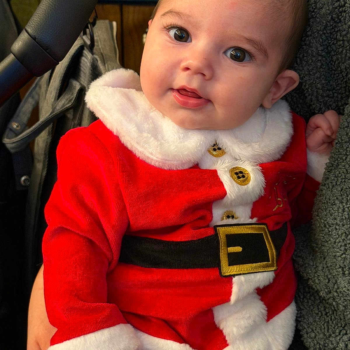 Bobby joined the competition — help win amazing prizes! baby, child, cozy, cute, eyes, face, festive, hand, holiday, indoor, infant, person, portrait, red_clothing, santa_claus_outfit, seat, smiling, stroller, warm, white_fur