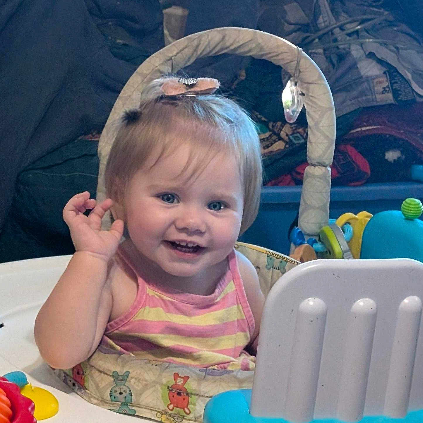 Jani Dale Grace is registered to the contest to win money with this photo: activity_seat, baby, cheerful, child, clothing, colorful, cute, expression, face, hair_clip, hand, happy, indoor, person, play, seat, smiling, toddler, toy, young