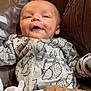 baby, baby_garment, blanket, brown_leather, child, clothing, cozy, cute, dimples, face, happy, hedgehog_pattern, indoor, infant, onesie, portrait, resting, seat, smiling, young