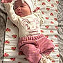 baby, infant, child, cute, white_bow, pink_pants, floral_blanket, lying_down, hand, reaching, soft_light, indoors, hat, clothing, newborn, portrait, person, cozy, sleepy, fabric