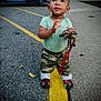 Apollo is registered to the contest to win money with this photo: accessories, asphalt, camo_pants, casual_clothing, child, crocs, curious, daylight, keys, looking_up, outdoor, parking_lot, person, red_lanyard, short_sleeve_shirt, sidewalk, standing, toddler, yellow_line, young_child