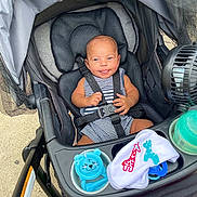 Apollo joined the competition — help win amazing prizes! baby, stroller, infant, smiling, striped_clothing, baby_toys, pacifier, fan, seat_belt, outdoor, child, cute, happy, baby_bib, plastic_toy, fabric, black_seat, safety_harness, skin, head