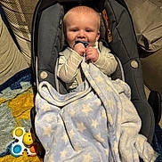 Finlay joined the competition — help win amazing prizes! baby, blanket, car_seat, child, clothing, comfort, couch, cozy, face, home, indoor, infant, pacifier, person, plush_blanket, rug, seatbelt, smiling, soft_toy, toy