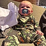 Finlay joined the competition — help win amazing prizes! baby, blanket, child, clothing, comfort, couch, cute, dinosaur_pattern, face, hand, home, indoor, infant, pacifier, pajamas, person, relaxed, sitting, tissue, wooden_wall